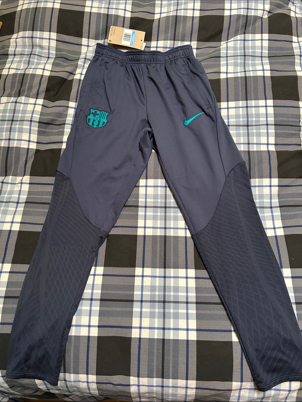Nike Kids Navy Training Joggers with Teal Barcelona logos.